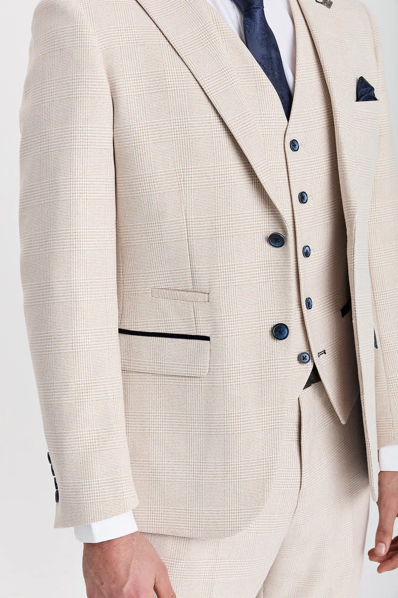 Close-up front view of a men's cream check suit jacket and waistcoat, showing dark blue buttons and a dark trim on the jacket pocket.