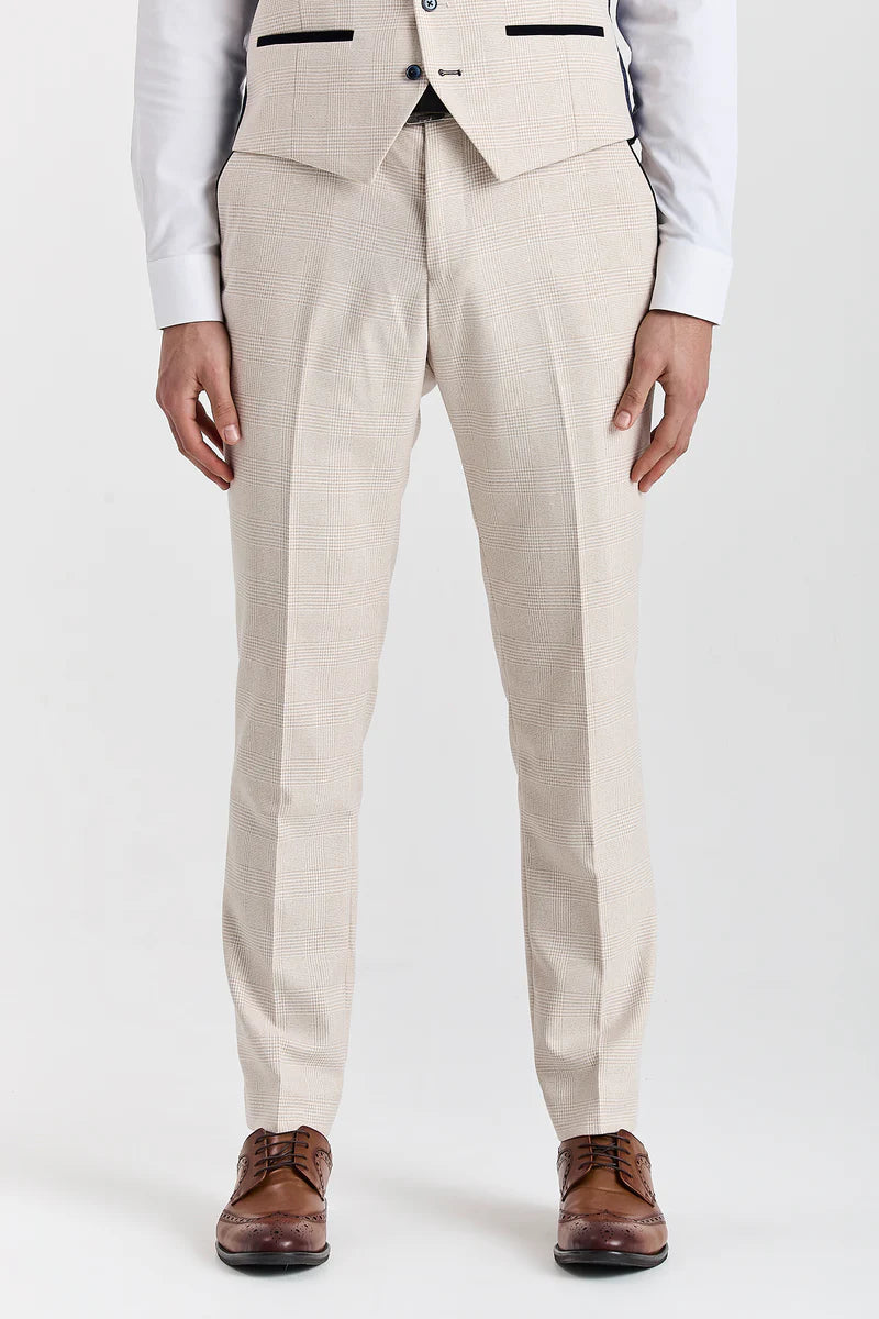 Front view of men's cream check suit trousers with a front crease, worn with brown brogues.