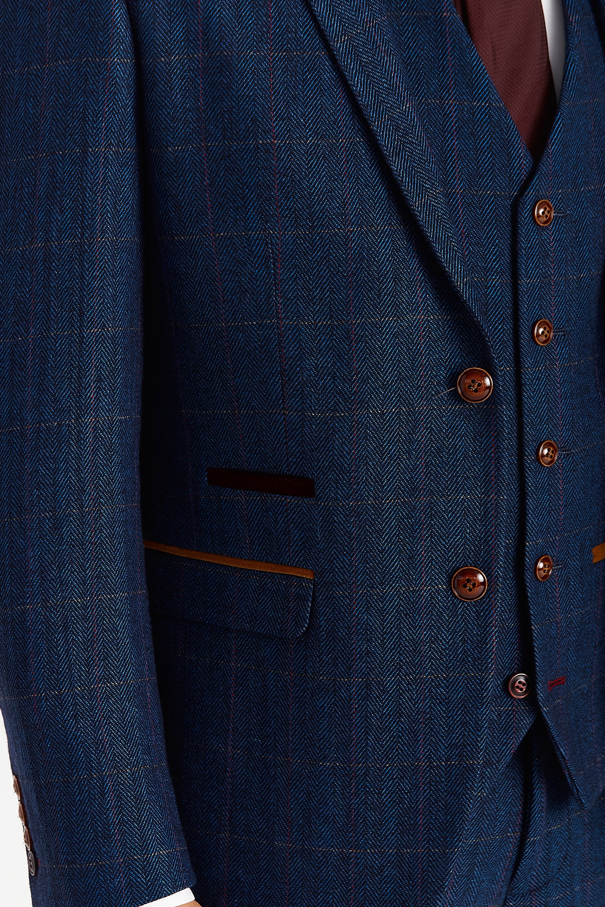 Close-up view of the Scott navy tweed check blazer showing the textured herringbone weave, subtle windowpane check, brown buttons and tan and burgundy suede trimmings.