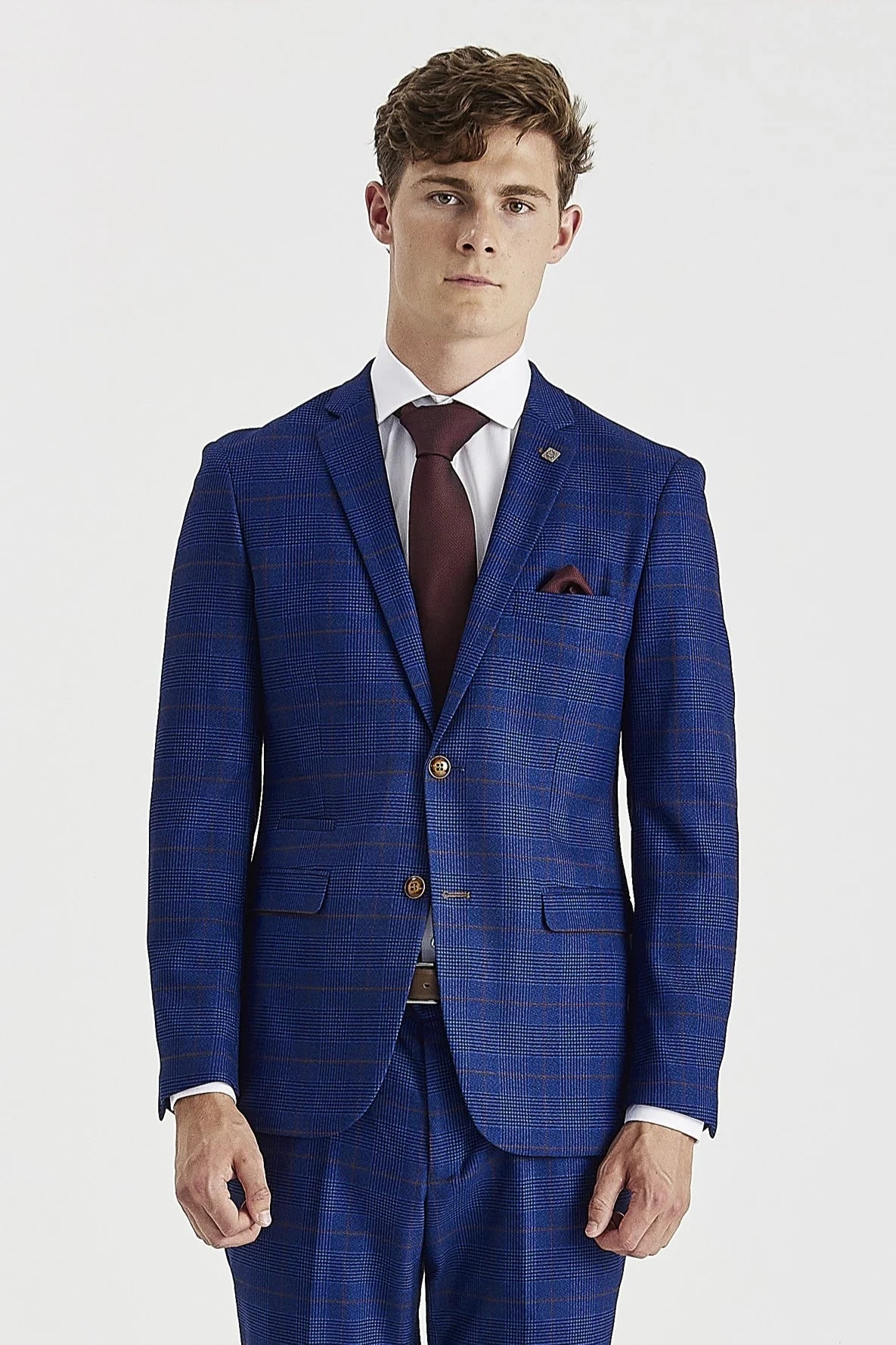 Front view from the waist up of a man wearing a tailored navy blue glen check suit jacket, paired with a crisp white shirt, burgundy tie, and a matching burgundy pocket square.