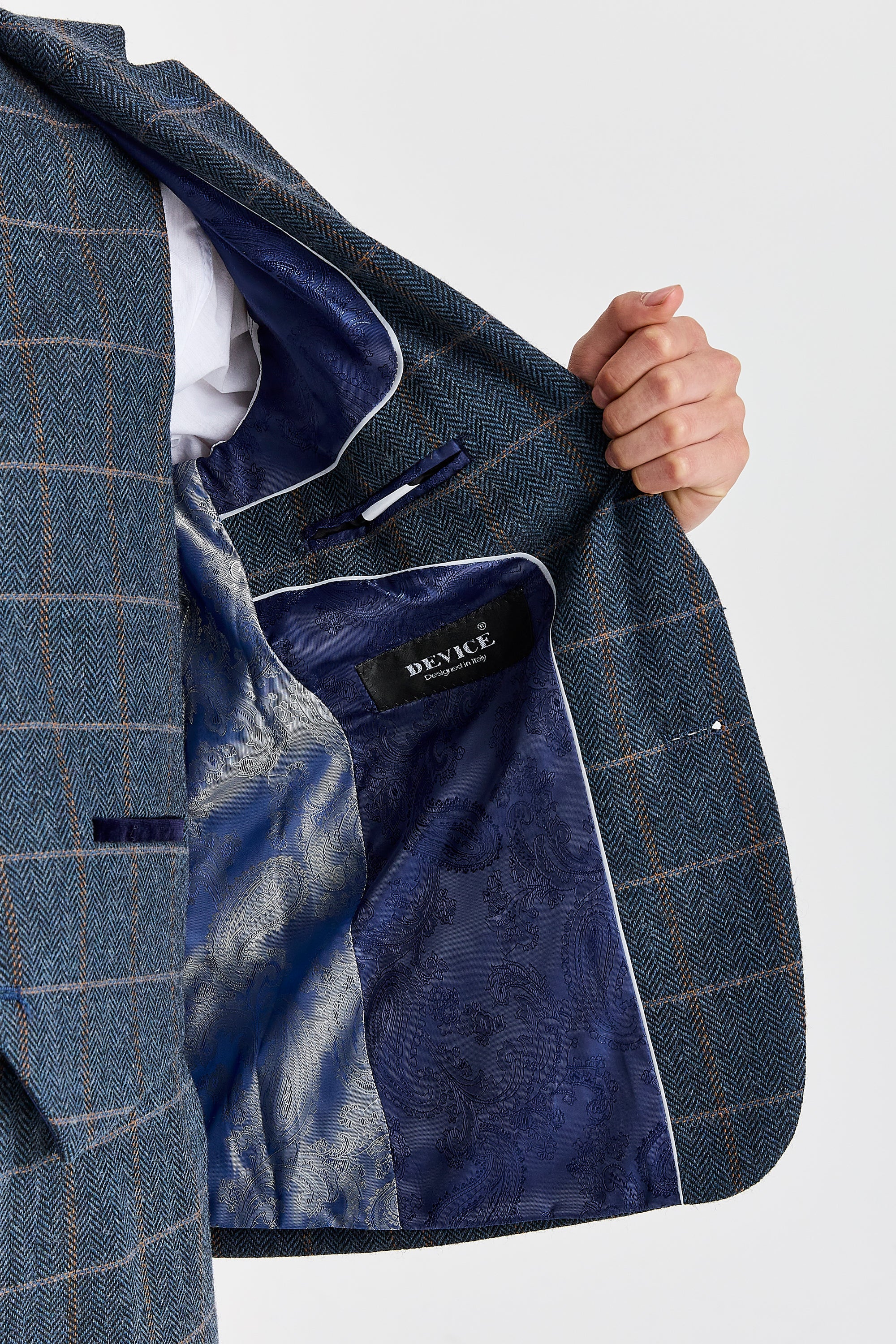 Interior view of navy herringbone tweed check blazer with silver and navy paisley lining.