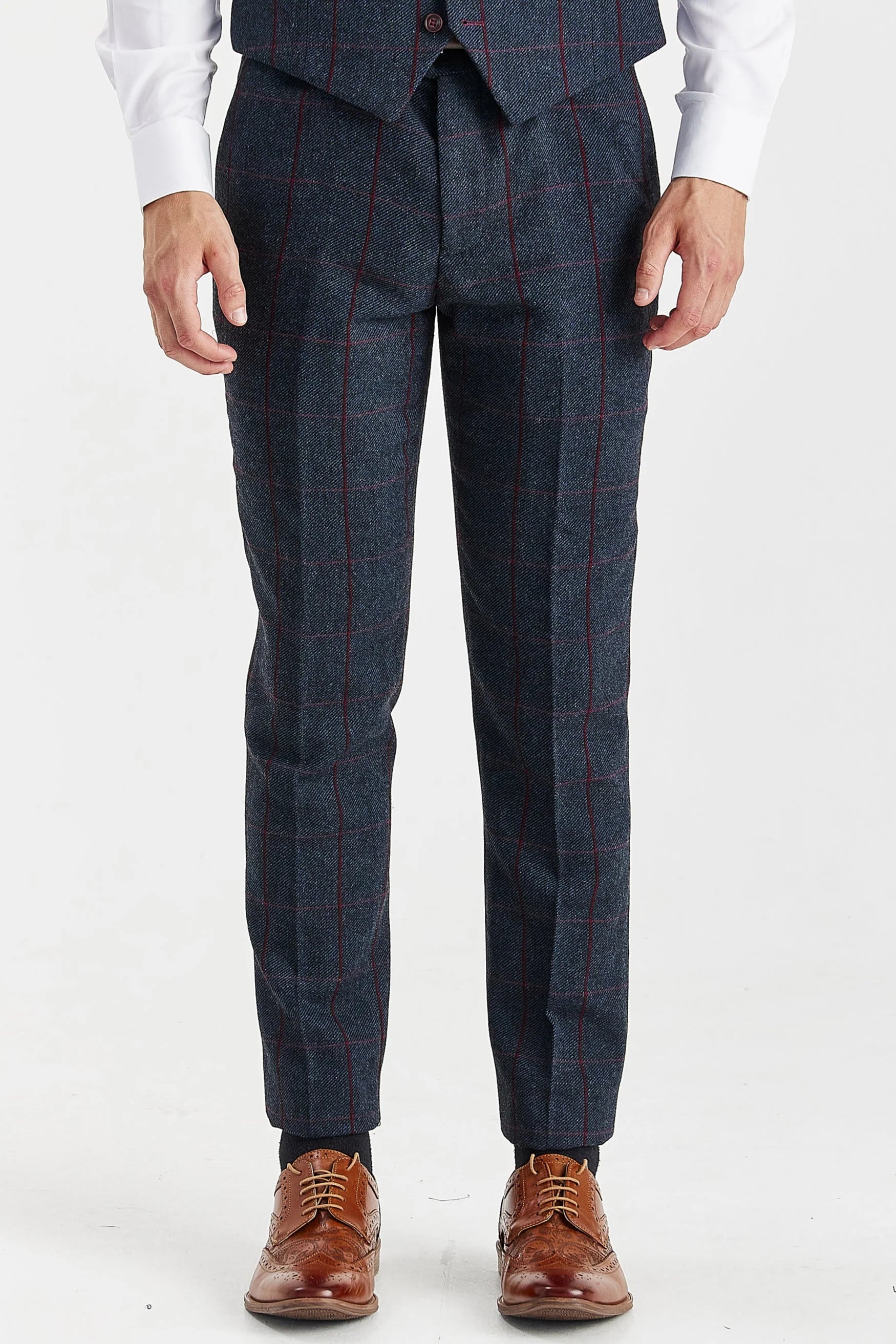 Front close-up of the matching Madrid navy tweed suit trousers and the bottom of the waistcoat, highlighting the red windowpane check pattern. Paired with brown brogues.