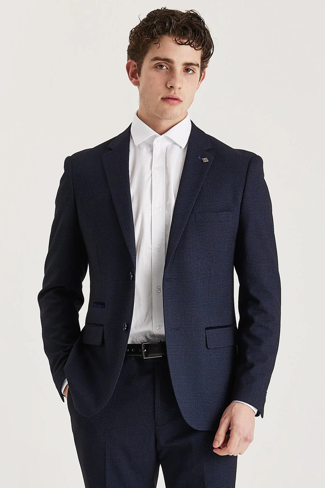 Front view of the navy check blazer, worn with matching trousers and a white shirt.