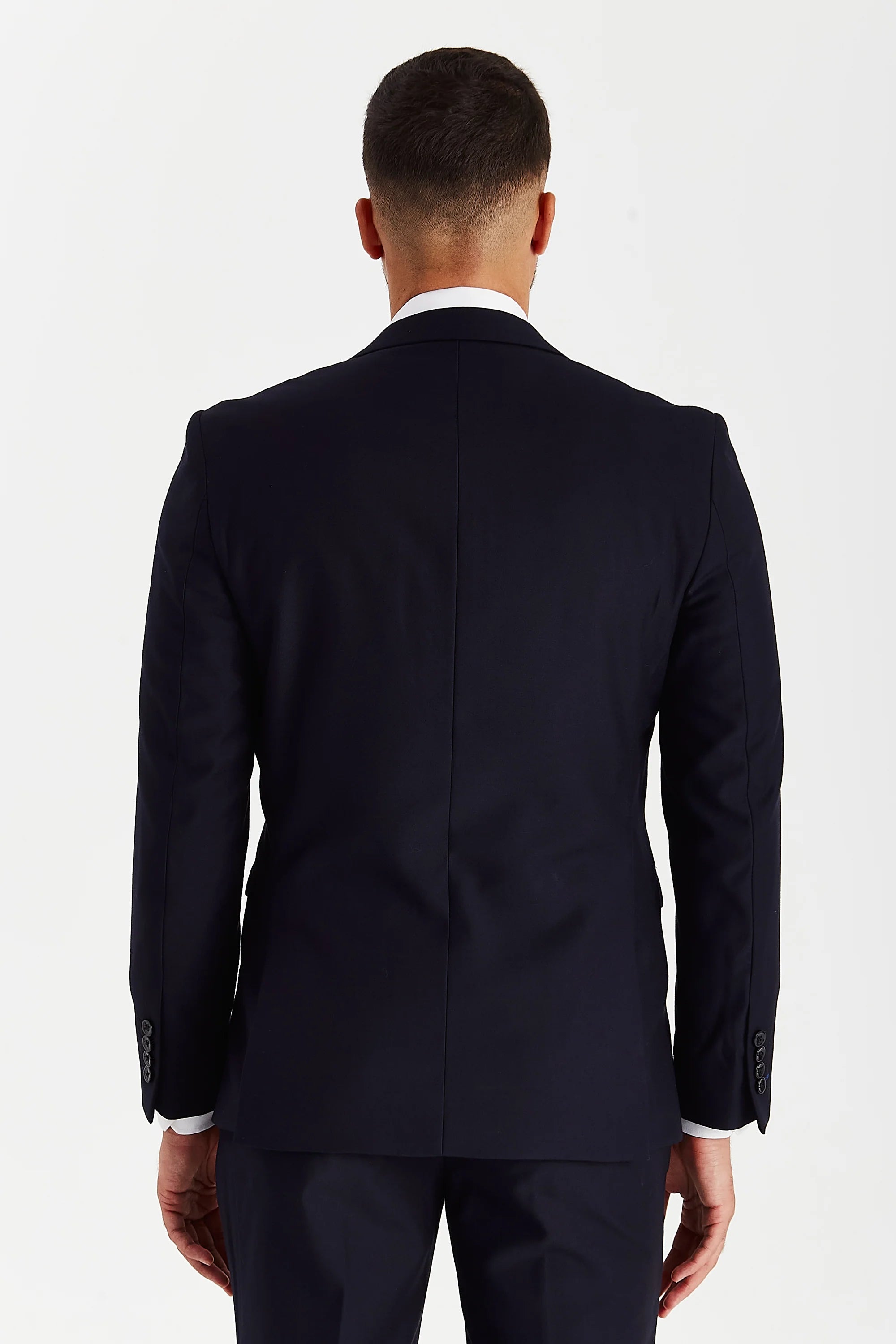 Back view of a Parker navy suit jacket with matching trousers and black sleeve buttons.