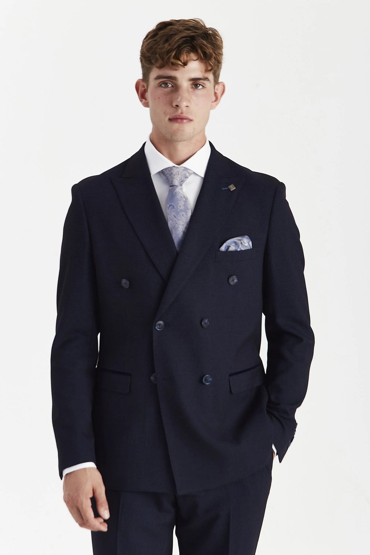 Front view of the Paul Andrew Regent men's navy check double-breasted suit jacket on a model, featuring peak lapels, a 6-button front, and flap pockets.