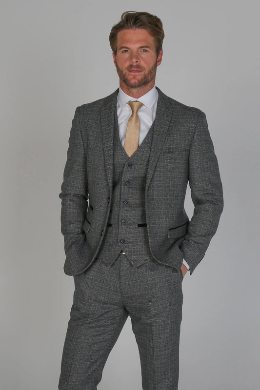 Ralph Navy Grey Men's Three Piece Suit with gold tie, close-up of model showing the detailed texture and fit of the jacket, waistcoat, and trousers.