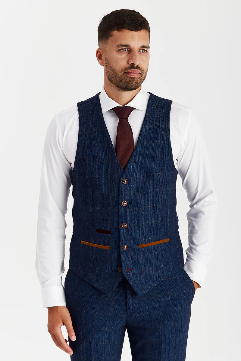 front view of the navy tweed check waistcoat worn over a white shirt with a burgundy tie, highlighting the brown buttons, pockets and structured fit