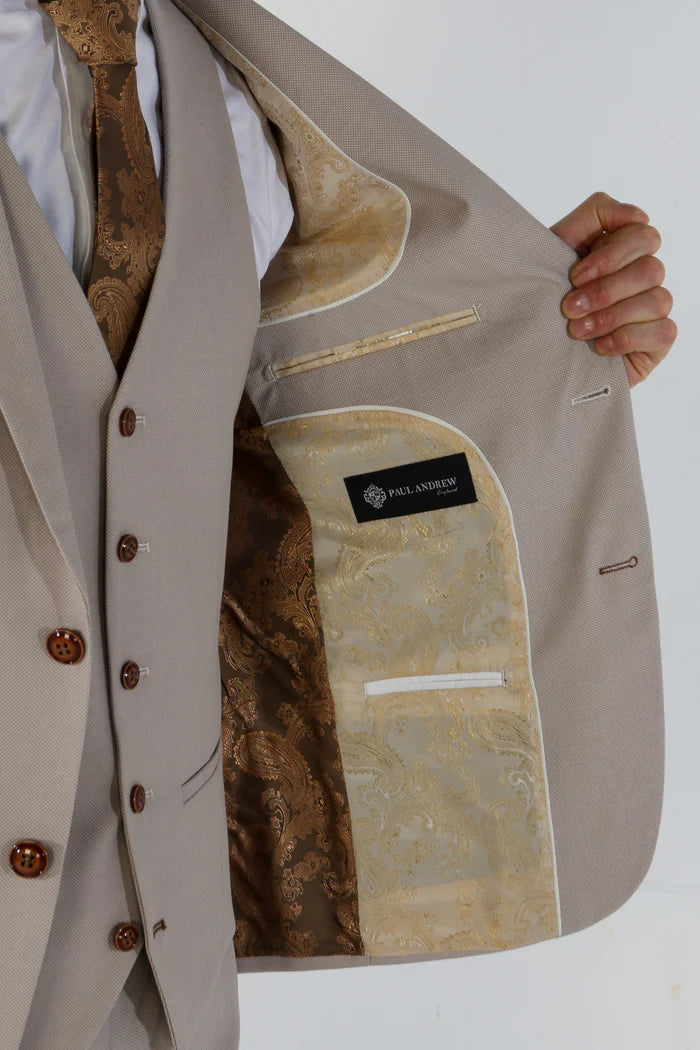 Interior view of the suit jacket showing cream and bronze paisley satin lining with Paul Andrew branding label.