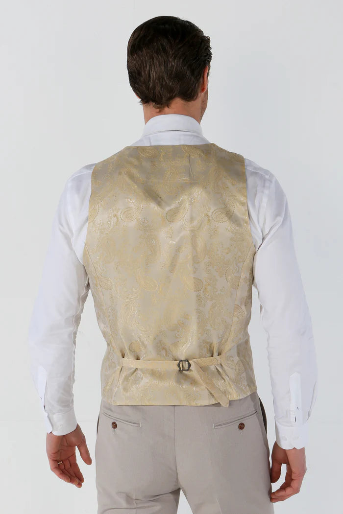 Back view of the waistcoat showing a cream gold paisley satin finish with adjustable strap, worn over a white dress shirt.
