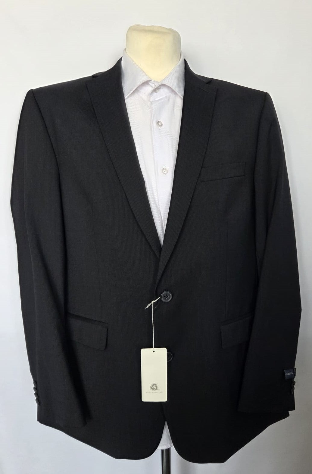  Straight-on front of black wool-blend suit jacket, modern fit with flap pockets and clean tailored lines.
