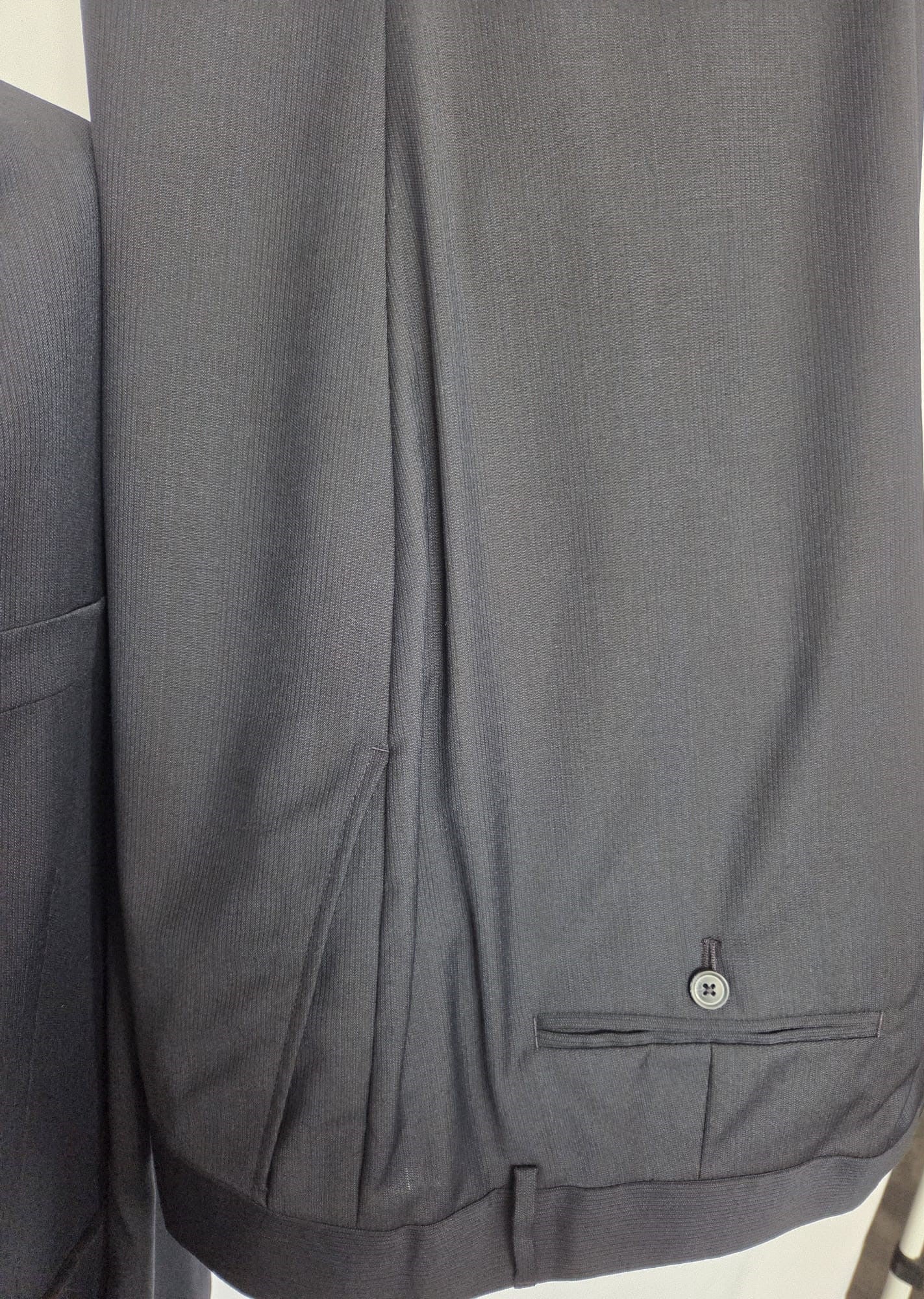 Dark navy suit trousers detail with rear pocket and button in matching 100% virgin wool.